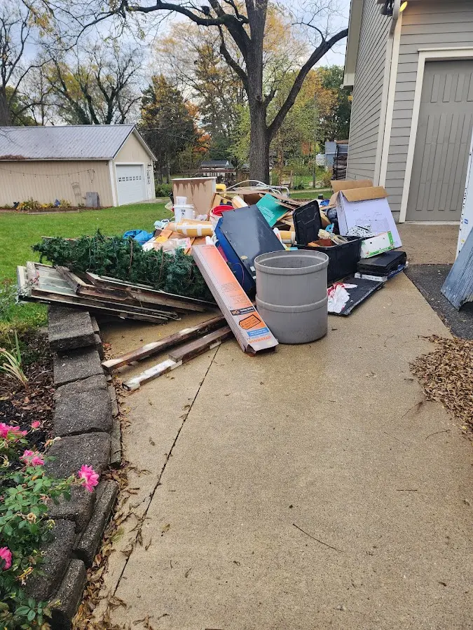 Dumpster being loaded with debris for 12 Yard Dumpster Rental in Upper Nazareth
